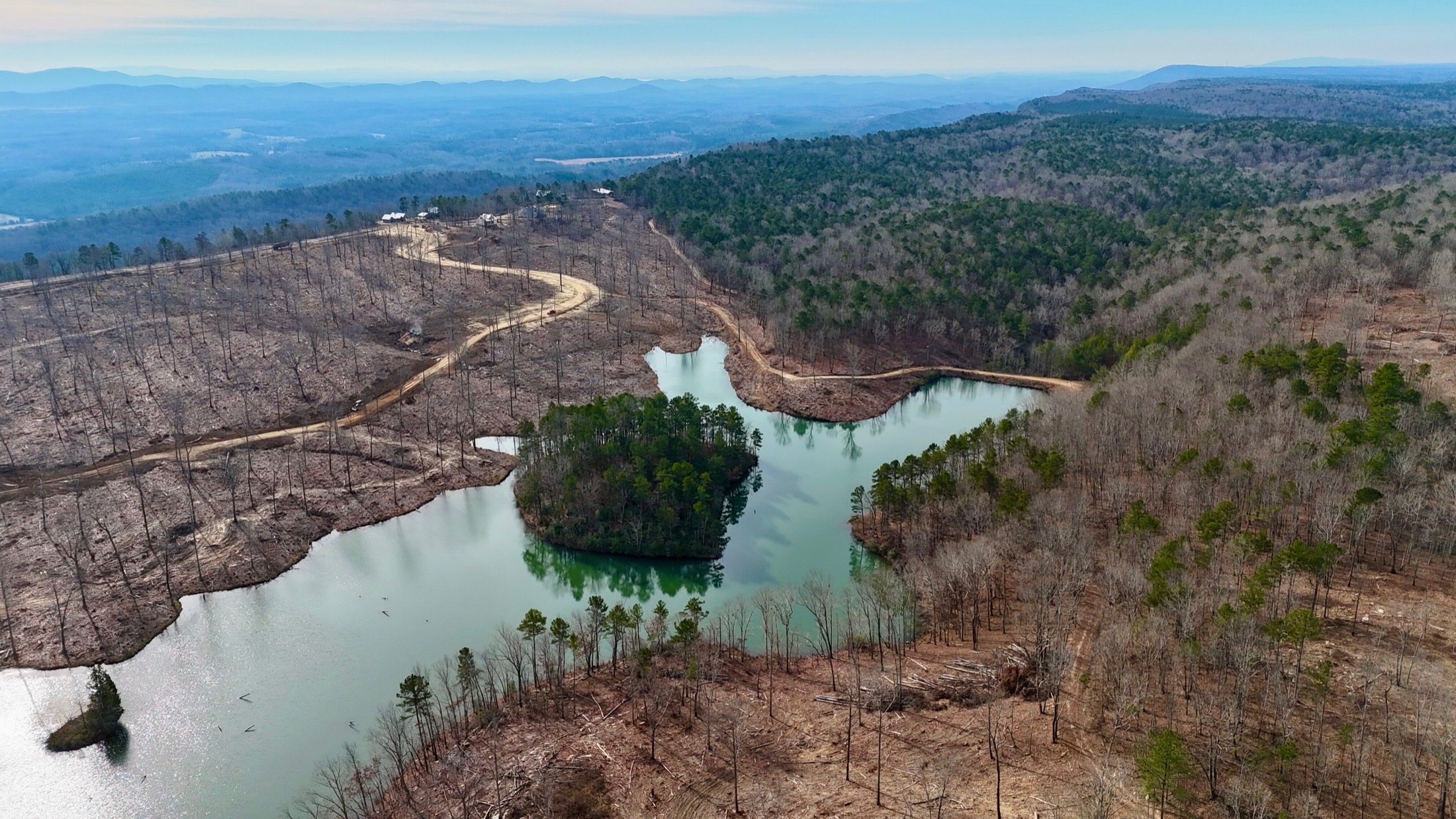 Aerial view of the lake, wooded island, roads, and surrounding Cairnwood land