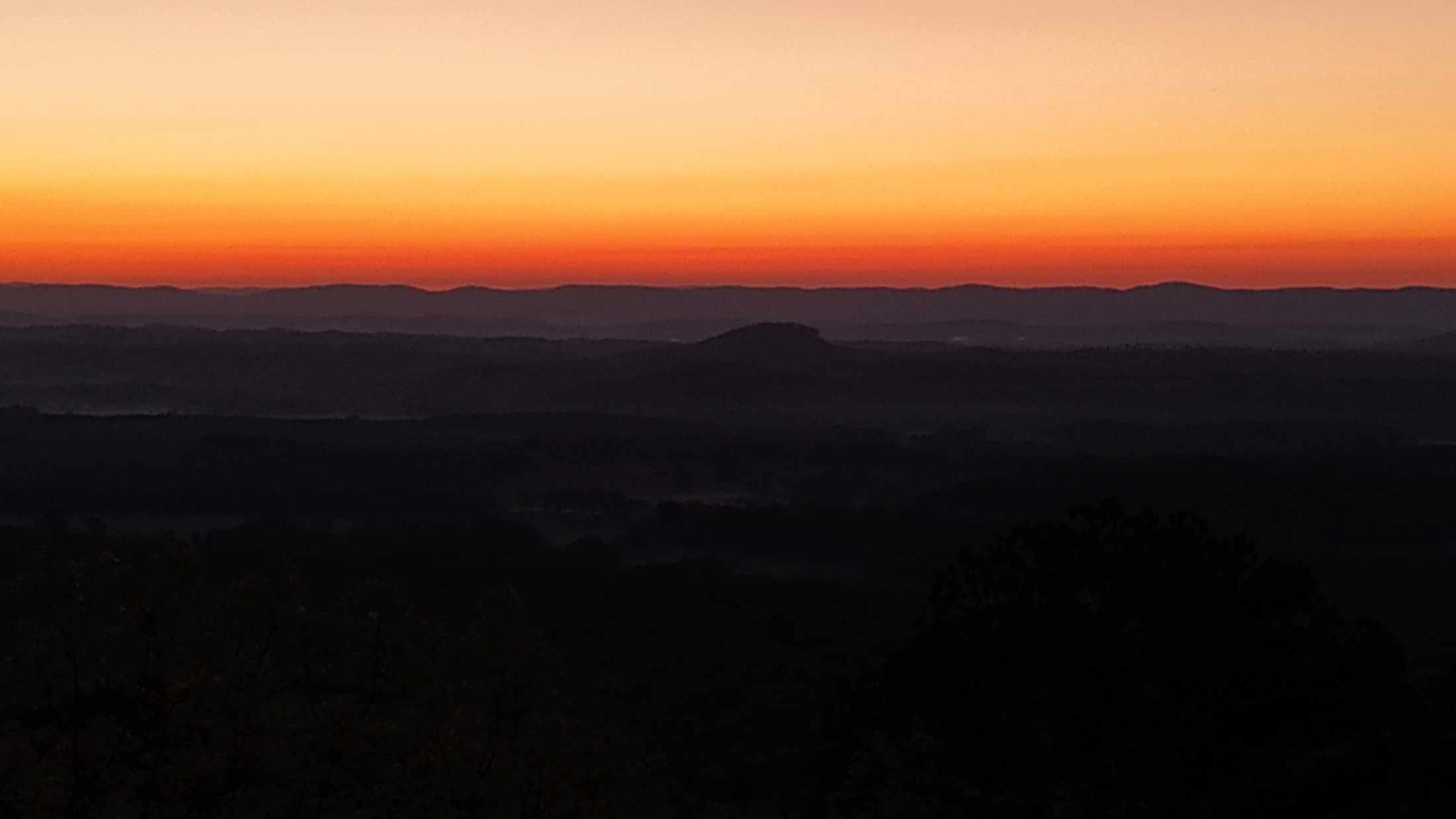 First light above layered mountain ridges seen from the Cairnwood property